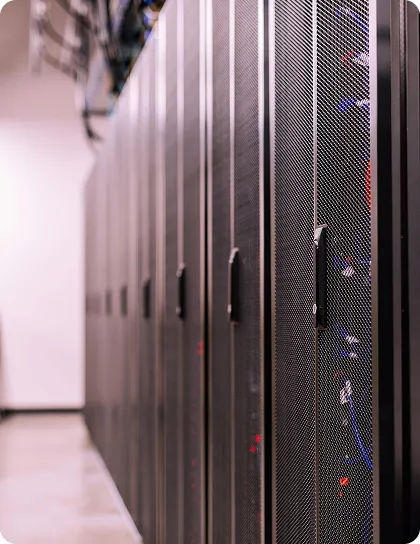 Who We Are Rows of server racks in a data center
